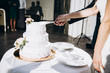 © Kateryna - Wedding cake. Newlyweds slice their beautiful and delicious wedding cake together