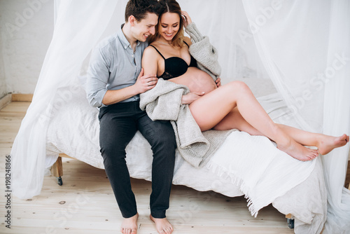 Happy Cheerful Couple The Husband Hugs His Pregnant