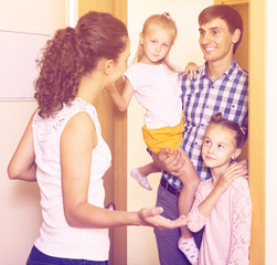 Wall Mural - Adults and kids meeting at doorway and greeting one another