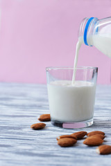 drink milk with almonds, hand pours into a glass