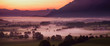 Breathtaking morning lansdcape of small bavarian village covered in fog. Scenic view of Bavarian Alps at sunrise with majestic mountains in the background.