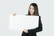 © Windawake - Asian businesswoman holding blank white card board sign.