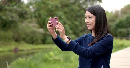 Sticker - Woman taking photo with cellphone at outdoor