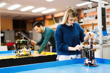 young student of robotics working on project