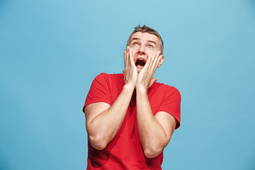 Wall Mural - Handsome man in stress isolated on blue