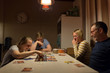© StudioWout - Family playing a game together in the evening