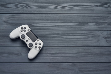 Computer game competition. Gaming concept. Top view of a joystick on wooden planks