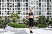 Fit Woman Skipping Rope In Urban Environment