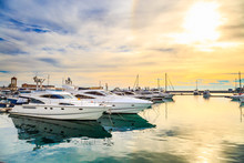 Luxury Yachts At Sunset. Marine Dock Of Modern Motor And Sailing Boats In Sunshine, Blue Water Sea, Rainbow With Sun. Travel And Fashionable Vacation.