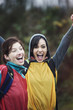 © Mint Images - Two women cheering at an informal outdoor sporting event.