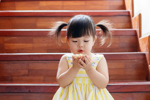 Little Girl Eating Cup Cake.