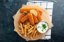 Fish Fingers And Fries With Sauce On Dark Background. Top View.