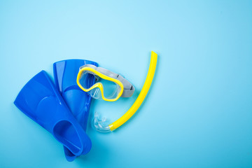 Blue flippers on color background