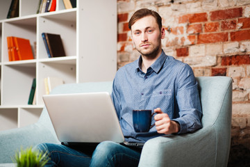 Wall Mural - Young man with a laptop