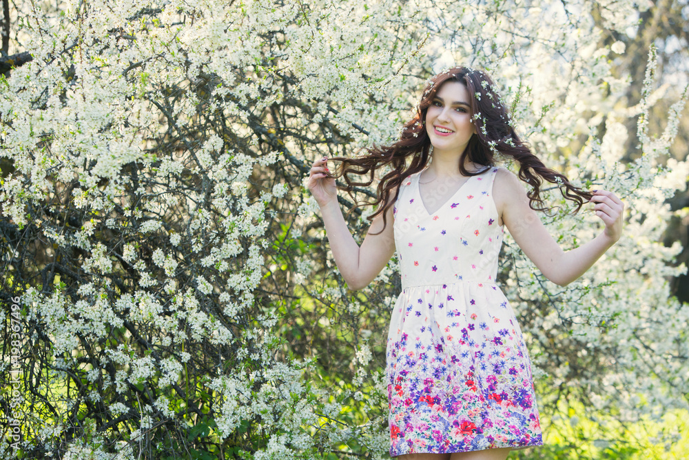 ensual young beautiful girl posing in spring in garden full of trees in ...