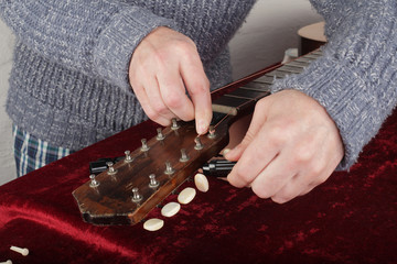 Wall Mural - Guitar repair and service - Worker fix new strings