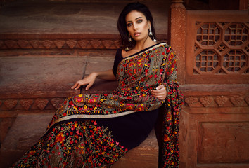 beautiful nice woman sit on the stairs in agra at taj mahal