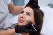 © romannoru - Close up beautiful female face and cosmetologist's hands with syringe during facial beauty injections. Rejuvenation and hydratation. Cosmetology concept