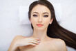 © Maksymiv Iurii - Body care. Face massage. Beautiful young woman relaxing with hand massage at beauty spa salon.