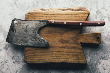 Wall Mural - Old rustic axe for meat on a wooden board on grunge background. Food photography