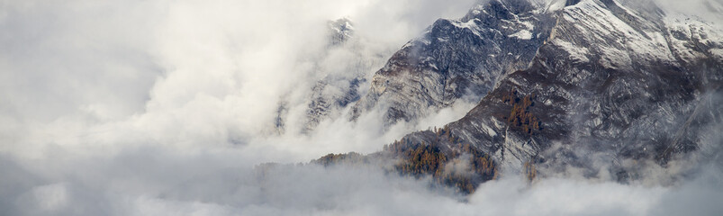 Aerial image of beautiful mountain landscape with clouds in the Valais Kanton