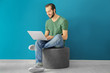 © Africa Studio - Young man using laptop indoors