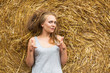 © AnastazjaSoroka - A smiling young woman with a blond with disheveled hair on the background of hay. Copy space. Nasty hair concept.