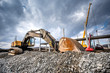 Heavy duty industrial excavator loading gravel on construction site. Details of building site