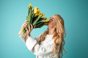 Wall Mural - Portrait of a beautiful young blonde woman in sweater