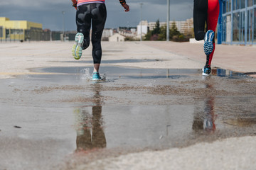 young adults couple running together