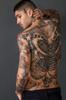 Handsome man back portrait with tattoos all over his body