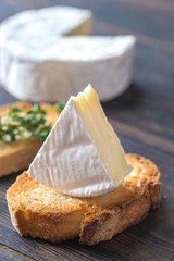 Wall Mural - Toast with Camembert cheese on the wooden board