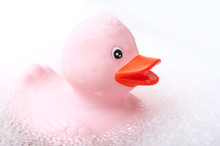 Closeup Of Pink Rubber Duck Toy With Moss In Bath