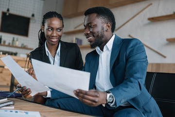 african american businesspeople discussing new business project in cafe