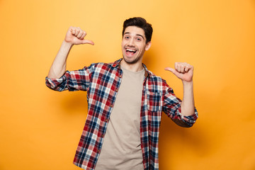 Poster - Portrait of a confident young man pointing fingers