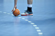 handball ball laying on the 9 meters dotted line on the pitch