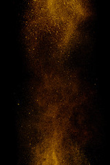 Gold dust on a black background. Fine particles in motion.