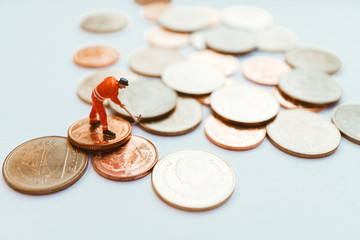 Miniature people, engineer working on stack coins using as business and financial concept - Vintage filter