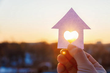 House with a carved heart on of sunrise.