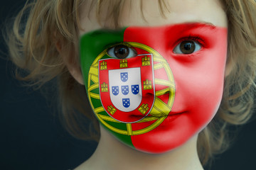 Portrait of a child with a painted Portugal flag