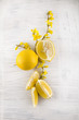 fresh ripe lemons, slices, rustic food photography on white wood plate kitchen table can be used as background