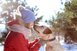 © Africa Studio - Portrait of woman with cute dog outdoors on winter day. Friendship between pet and owner
