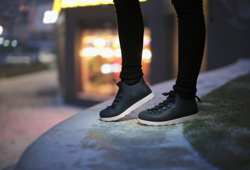 Canvas Print - Young woman in winter shoes on street at night