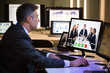 © Andrey Popov - Businessman Video Conferencing With Happy Colleagues On Computer