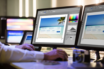 Wall Mural - Designer Working On Multiple Computer Screen