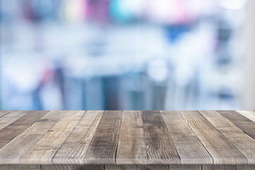 Wall Mural - empty wooden table for product placement or montage with focus to table top in the foreground, with 