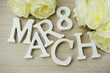 march women's day with spring flowers on wood background top view