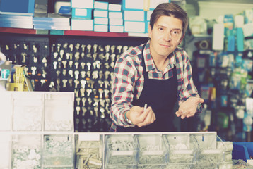 Wall Mural - Worker man in hardware store is trading goods for construction