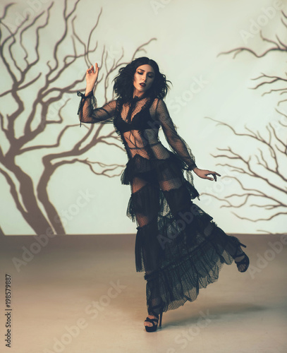 An Alien Girl In A Black Transparent Vintage Dress Posing