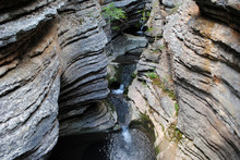 Mountain Stream And Geological Layers Of A Sediment Rocks Canyon